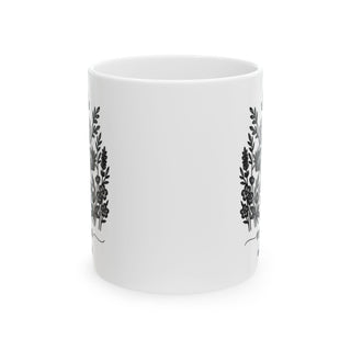 White mug with repeating black floral wreath design.