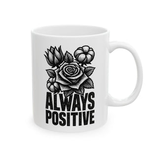 White mug with black floral design and "ALWAYS POSITIVE" text.