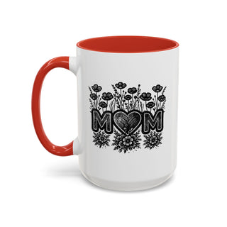 White mug with red handle and interior featuring "MOM" with heart and floral design.