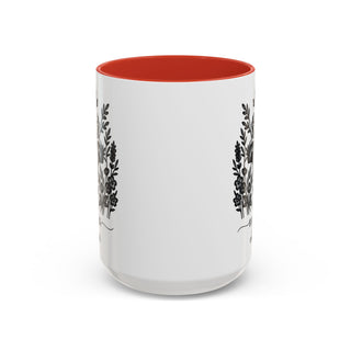 White mug with floral design and orange interior.