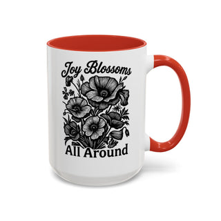 White mug with red interior and handle featuring floral design and "Joy Blossoms All Around" text.