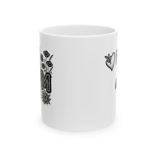 White mug with "MOM" in bold letters and floral design.
