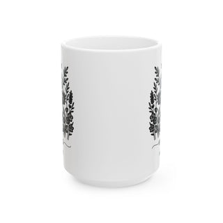 White mug with black floral wreath design on both sides.