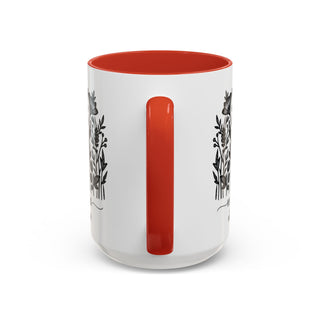 White mug with orange interior and floral line art design.