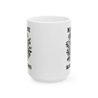 White mug with floral design and text "MADE TO BLOOM ALWAYS".