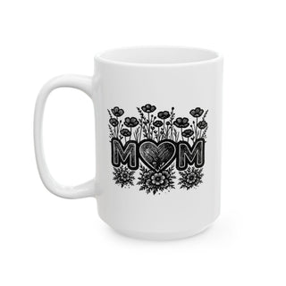 White mug with black "MOM" text and floral design.