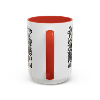White mug with red interior, featuring floral designs and text "Joyful Blooms All Around".