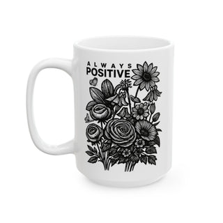White mug with "ALWAYS POSITIVE" and a floral illustration.