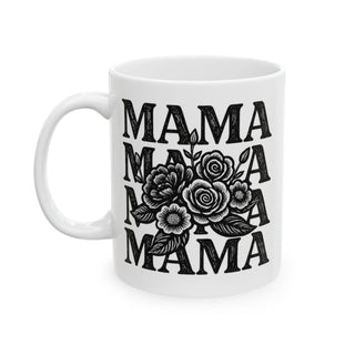 White mug with black text "MAMA" stacked with floral design.