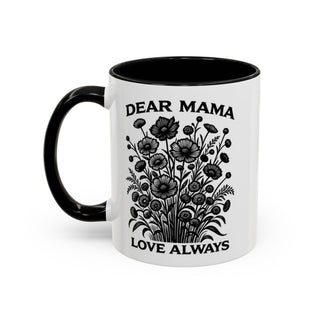 White mug with black rim and handle, featuring "DEAR MAMA LOVE ALWAYS" and floral illustration.