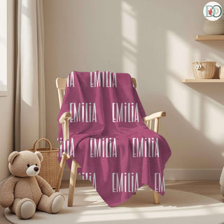 personalized name blankets in soft green, dusty lilac, deep rose, blush, and charcoal grey—each featuring a custom name in unique fonts for a cozy, heartfelt keepsake.