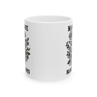 White mug with floral designs and text "MAN I LOVE BLOODY ALWAYS".