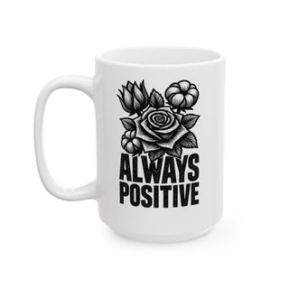 White mug with black floral design and "ALWAYS POSITIVE" text.