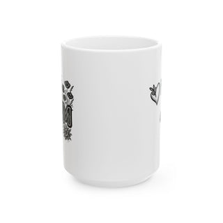 White mug with floral "MOM" text and heart design.