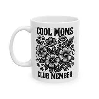 White mug with "Cool Moms Club Member" text and floral illustration.