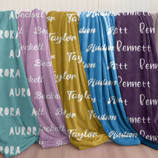 Personalized name blankets in vibrant tones including teal, lavender, mustard, blue, and plum. Features custom fonts and cozy sherpa or minky backing.