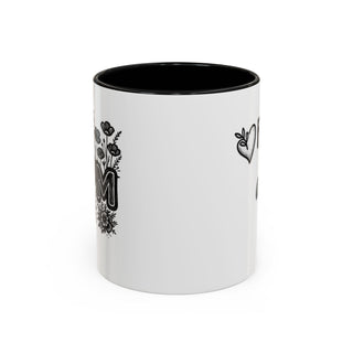 White mug with "Mom" in floral lettering and a heart illustration.