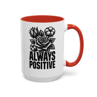 White mug with red handle, featuring a black rose and cotton branch illustration and "ALWAYS POSITIVE" text.