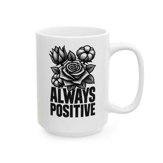 White mug with black text "ALWAYS POSITIVE" and floral design.