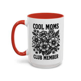 Mug with "Cool Moms Club Member" text and floral illustration.