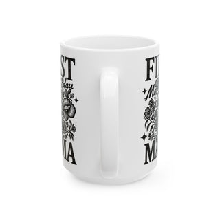 White mug with "First Mother's Day" and floral illustrations.