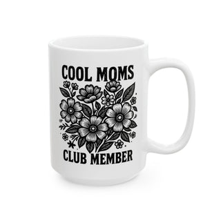 White mug with black floral design and text "COOL MOMS CLUB MEMBER".