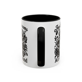 Black and white mug with floral design and text "Joy all around".