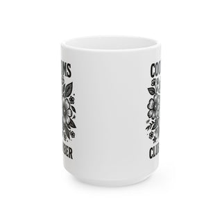 White mug with floral designs and text "Coolest Mom Ever".