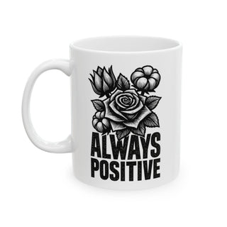 White mug with black line art of rose, flowers, and text "ALWAYS POSITIVE".