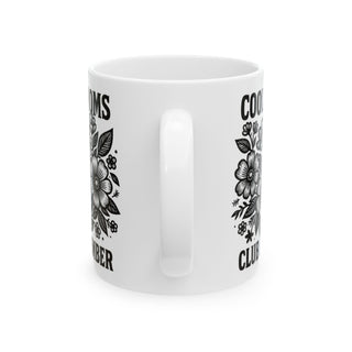 White mug with floral design and text "COOMS CLUB DECEMBER".