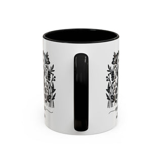 White mug with black floral designs and black interior.