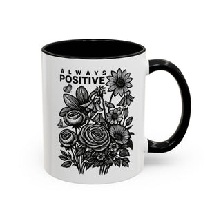 White mug with black handle, featuring floral illustration and "ALWAYS POSITIVE" text.