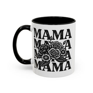 White mug with black handle and interior, featuring "MAMA" repeated with floral illustration.