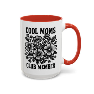 White mug with red interior and handle, featuring "Cool Moms Club Member" text and floral design.