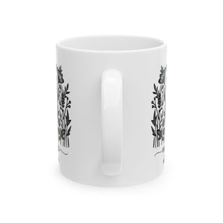 White mug with floral design on both sides.