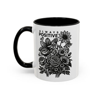 White mug with black handle featuring floral illustration and "ALWAYS POSITIVE" text.