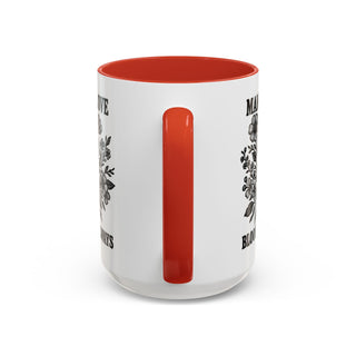 White mug with red interior and floral designs reading "MAY LOVE BLOOM ALWAYS".
