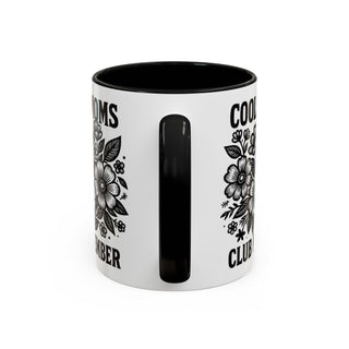 Black and white mug with floral design and text.