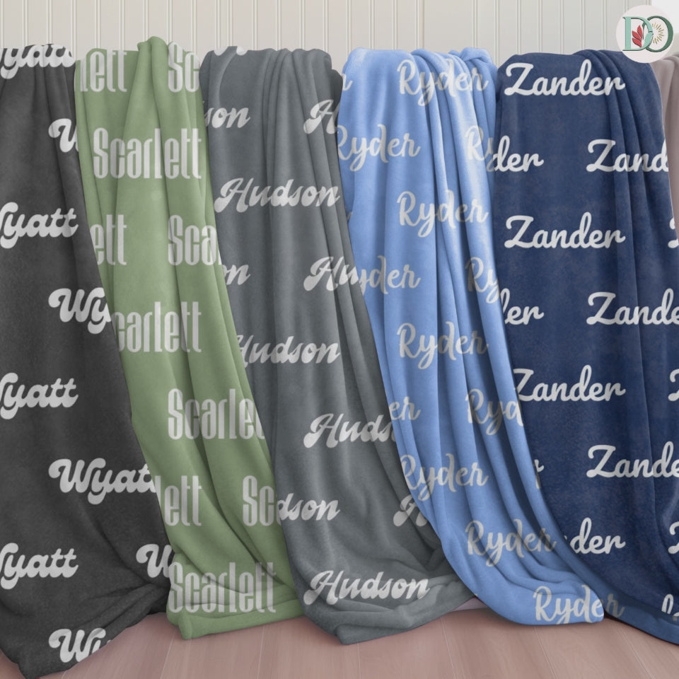 personalized name blankets in tones of navy, sky blue, graphite grey, sage green, and black — soft and comforting with gentle fonts in Doveora's Starshade Nest collection.